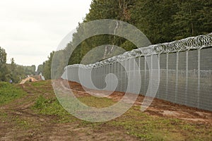 Barbed wire steel wall against the immigrations in Europe photo