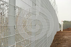 Barbed wire steel wall against the immigrations in Europe photo