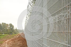 Barbed wire steel wall against the immigrations in Europe photo