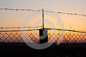 Barbed wire at sunset