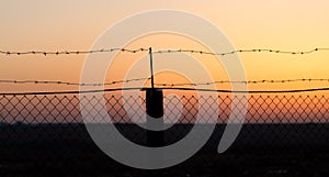 Barbed wire at sunset