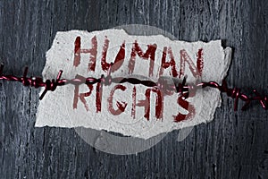 Barbed wire and text human rights