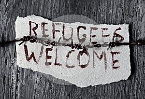 Barbed wire and text refugees welcome photo