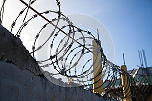 Barbed Wire on top of a old Wall