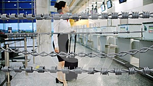 Barbed wires against air hostess walking in airport
