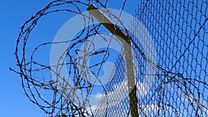 Barbed wires and large fence, created to block immigrants