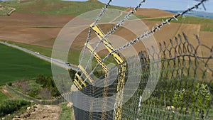 Barbed wires and large fence, created to block immigrants
