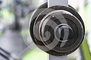 Barbell discs hanging on a rack in the gym.