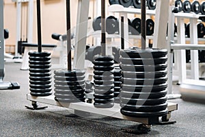 Barbell discs stacked in rows in the gym