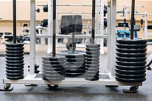 Barbell discs stacked in rows in the gym