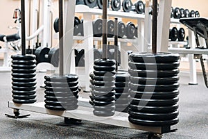 Barbell discs stacked in rows in the gym