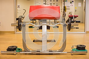 Barbell with elbow support in gym room for weight training, muscle building