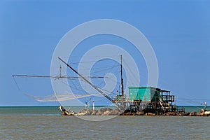 Barbell fishing shed or fishing hut at the river mouth