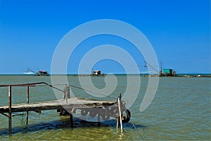 Barbell fishing shed or fishing hut at the river mouth