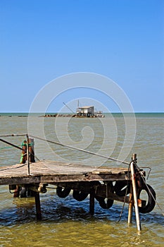 Barbell fishing shed or fishing hut at the river mouth