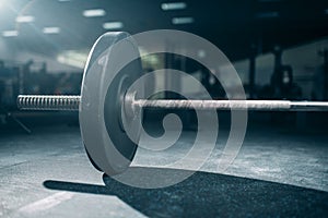Barbell on the floor in gym closeup view, nobody