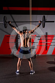 Barbell weight lifting man rear view workout gym