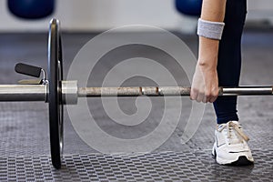 Barbell, woman hands and weightlifting exercise for fitness, workout and sports challenge in gym. Closeup female athlete