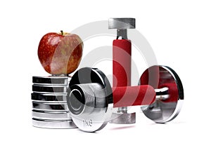 Barbells and apple isolated on white