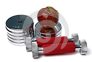 Barbells and apple isolated on white