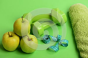 Barbells by green apple. Healthy lifestyle and low calorie food