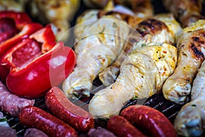 Barbeque with chicken, sausages and red peppers
