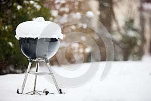 Barbeque grill covered with snow