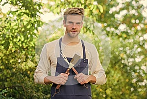 Barbeque party. Picnic concept. Bbq chef. Handsome guy cooking food. Cooking burgers. Man hold barbeque equipment
