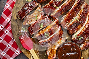 Barbeque ribs sliced on round wooden cutting board