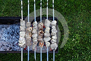 Barbeque skewers with meat rotating and cooking on the grill out