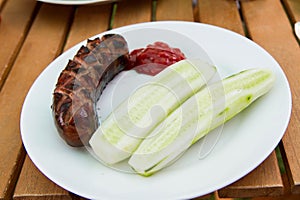 Barbequed Sausage served with fresh cucumber