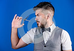 Barber with beard and mustache hold steel scissors. Grooming beard. Create your style. Macho bearded barber hold