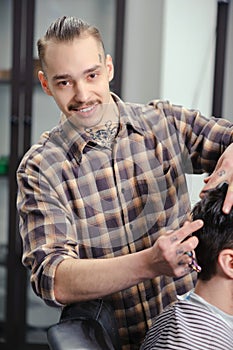 Barber cuts hair of a man