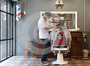 Barber cutting hair at a barber shop
