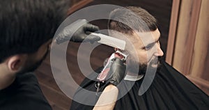 Barber cutting hair using hair trimmer