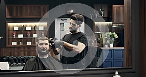 Barber cutting hair using trimmer