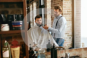 Barber Cutting Man Beard In Barber Shop. Beard Hair Cut