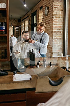 Barber Cutting Man Beard In Barber Shop. Beard Hair Cut