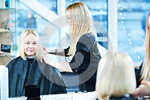 Barber or stylist at work. Hairdresser cutting woman hair