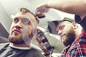 Barber or hair stylist at work. Hairdresser cutting hair of client