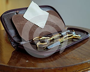 Barber Hairdresser Tool Set in Open Bag on Wooden Background