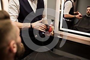 Barber holding hair gel pack