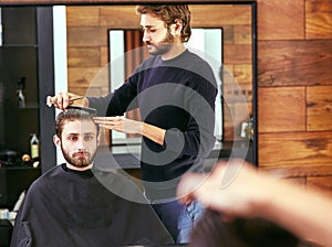 Barber makes men haircut at the beauty salon