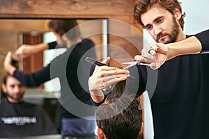 Barber makes men haircut at the beauty salon photo