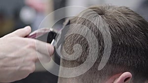 Barber making haircut using machine