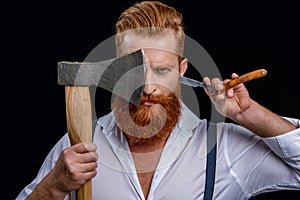 barber man in studio. barber man with ax and retro razor blade. photo of barber man