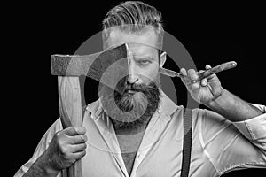 barber man in studio. barber man with ax and retro razor blade. photo of barber man