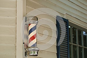 Barber pole on side of Barber Shop