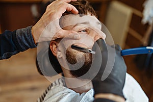 Barber with razor, old school beard cutting