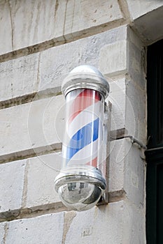 Barber round bleu red white round pole shop sign silver in vintage hairdresser facade